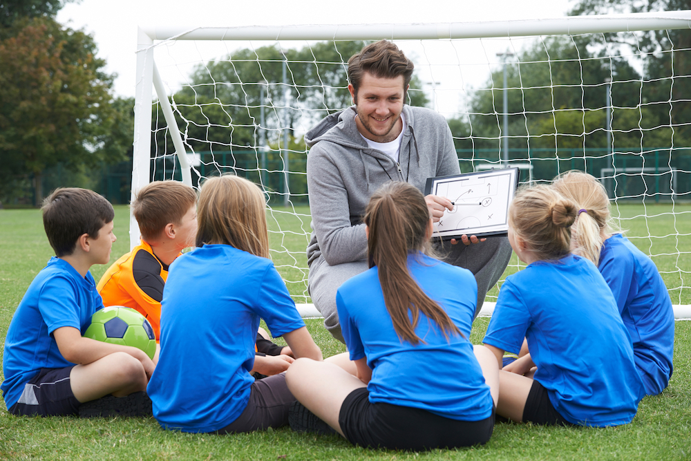 3stock-photo-coach-giving-team-talk-to-elementary-school-soccer-team