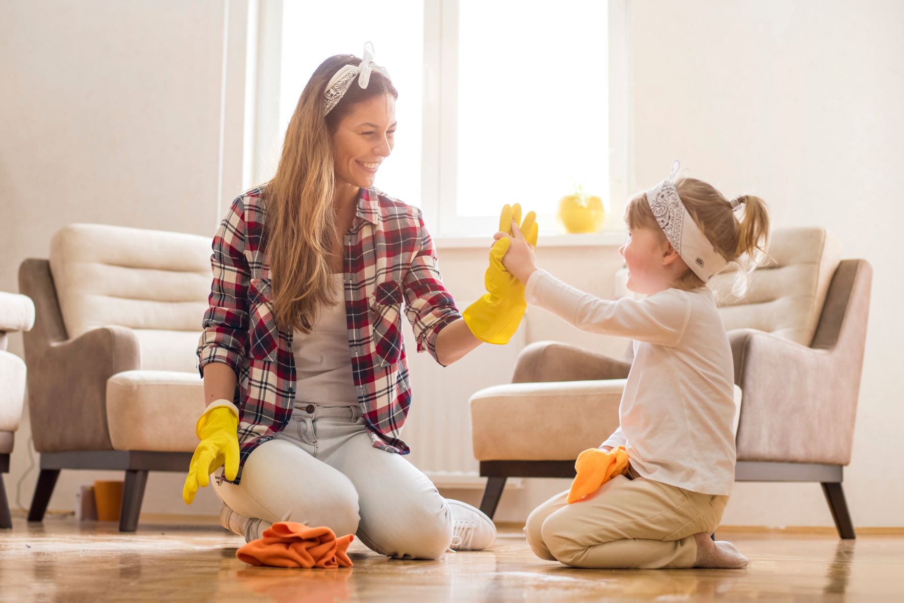 mother and daughter high fiving while cleaning
